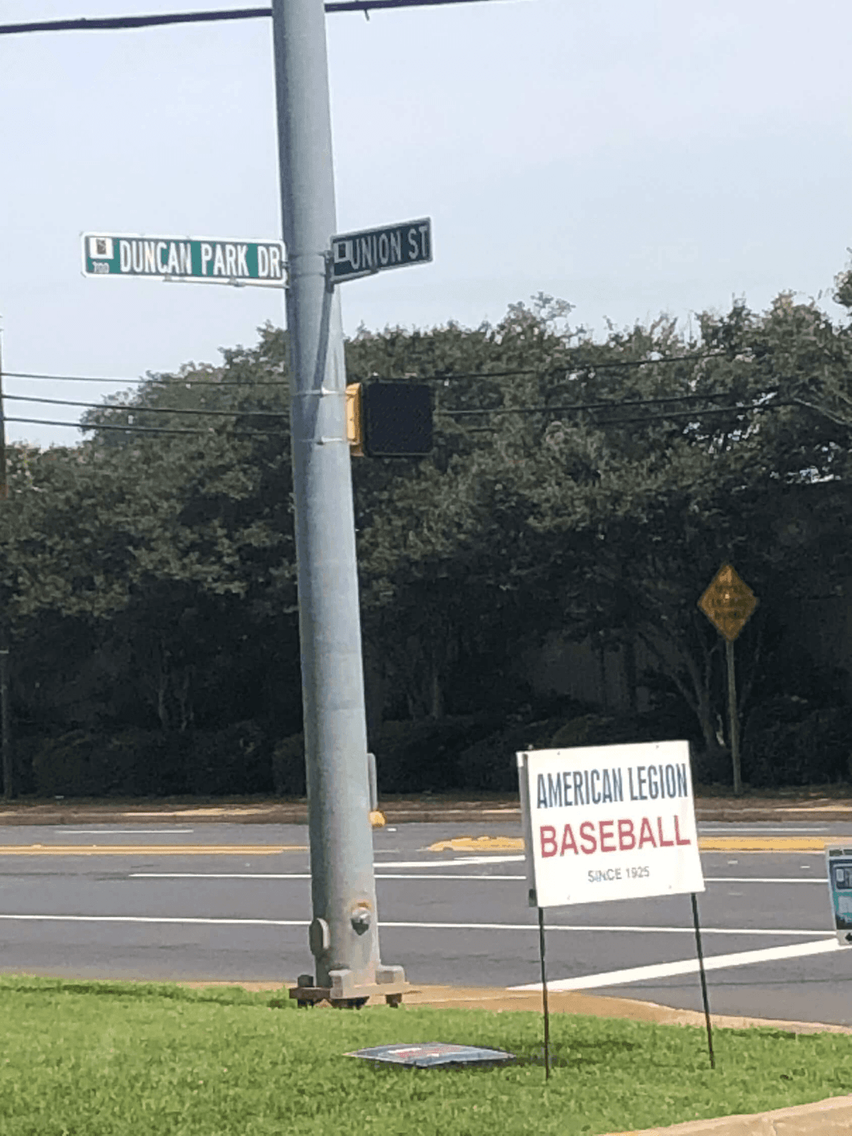 Street signs at the corner of Duncan Park Drive and Union Street in Spartanburg, with an American Legion Baseball "Since 1925" yard sign in the foreground.